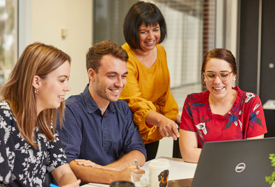 Students and trainer looking at computer