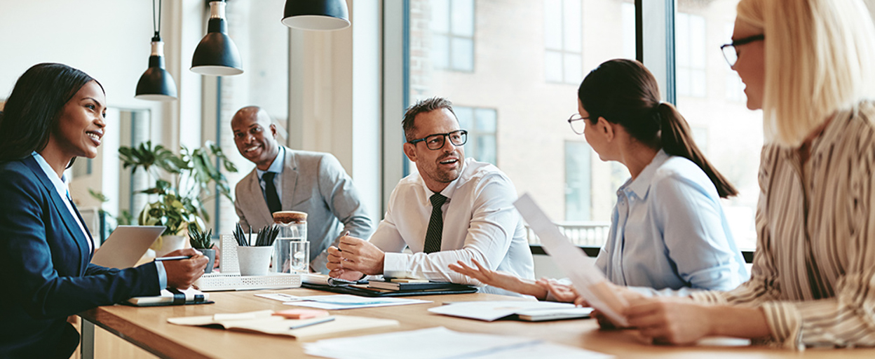 Group of people at desk with paperwork